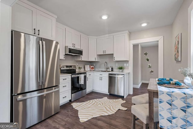 1686 Terry Mill Rd SE, Atlanta, GA 30316 - kitchen with stainless steel appliances, a sink, light countertops, white cabinetry, and recessed lighting