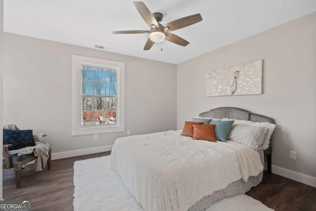 bedroom featuring visible vents, dark wood-type flooring, and baseboards