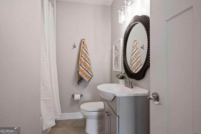 bathroom featuring curtained shower, baseboards, toilet, tile patterned floors, and vanity