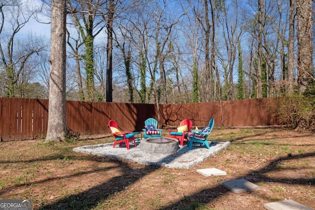 view of yard featuring a patio, a fenced backyard, and an outdoor fire pit