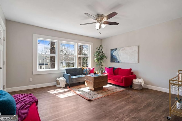 living room with wood finished floors, baseboards, and ceiling fan