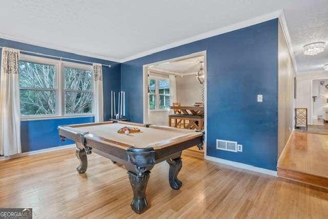 recreation room featuring billiards, baseboards, visible vents, ornamental molding, and wood finished floors