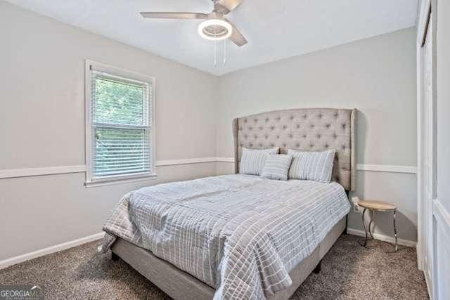 carpeted bedroom with baseboards and a ceiling fan