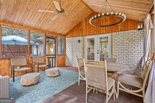 sunroom featuring a ceiling fan, lofted ceiling, wood ceiling, and french doors