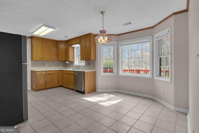 kitchen featuring appliances with stainless steel finishes, light countertops, visible vents, and tasteful backsplash