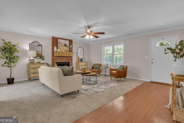 81 Bowers Rd, Moreland, GA 30259 - carpeted living room featuring a ceiling fan, a brick fireplace, ornamental molding, baseboards, and wood finished floors