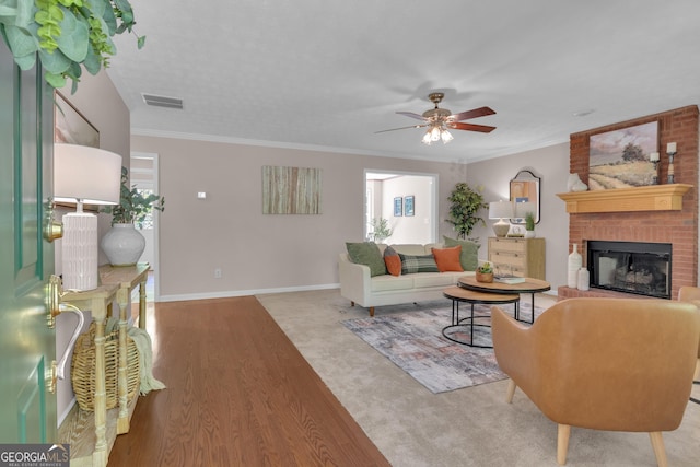 81 Bowers Rd, Moreland, GA 30259 - living area with ceiling fan, a fireplace, ornamental molding, baseboards, and wood finished floors