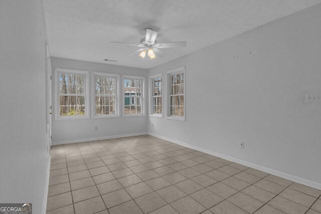 unfurnished room featuring visible vents, carpet flooring, a ceiling fan, and baseboards