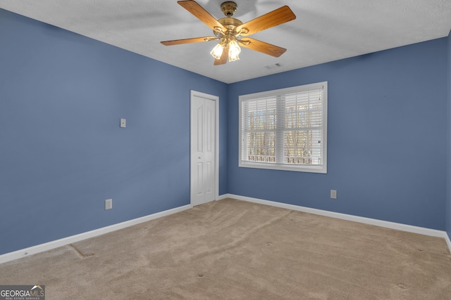 81 Bowers Rd, Moreland, GA 30259 - spare room featuring carpet flooring, baseboards, a ceiling fan, and a textured ceiling
