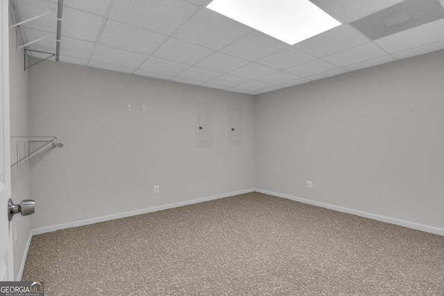 empty room featuring carpet, baseboards, and a drop ceiling