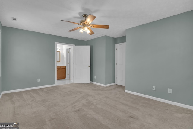 81 Bowers Rd, Moreland, GA 30259 - unfurnished bedroom featuring light carpet, baseboards, ensuite bath, and a ceiling fan
