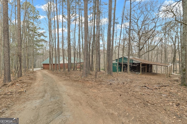 81 Bowers Rd, Moreland, GA 30259 - view of dirt / gravel road with an outbuilding and a forest view