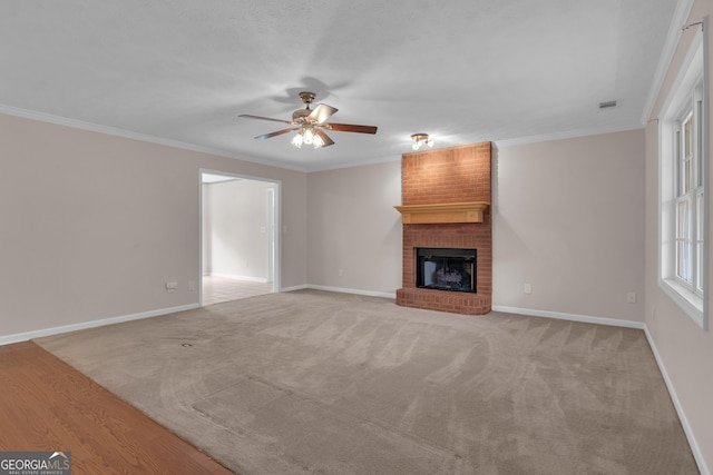 unfurnished living room featuring ornamental molding, a fireplace, visible vents, and light colored carpet