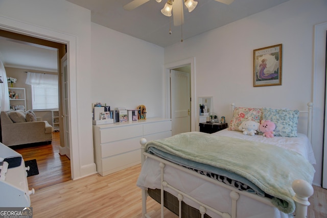 bedroom with light wood-style flooring and a ceiling fan