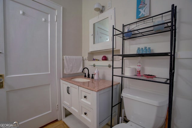 bathroom with toilet and vanity