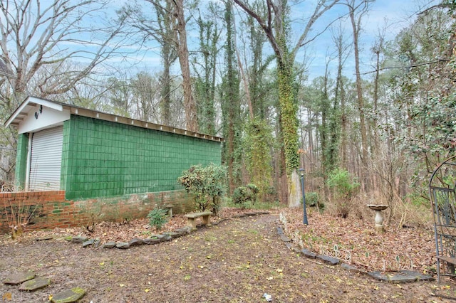 view of home's exterior with a garage and an outdoor structure