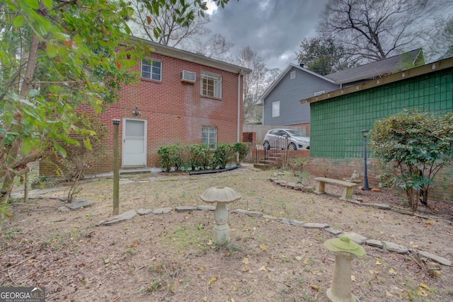 rear view of property with brick siding