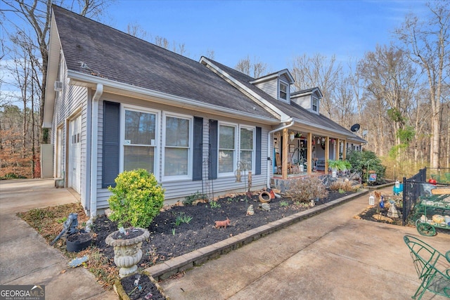 cape cod-style house with covered porch and roof with shingles