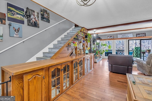 interior space with a textured ceiling and wood finished floors