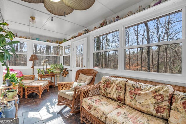 sunroom / solarium featuring vaulted ceiling