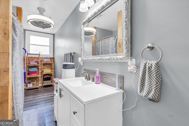 bathroom with wood finished floors and vanity