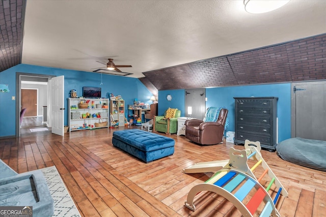 interior space featuring vaulted ceiling, hardwood / wood-style floors, and a ceiling fan