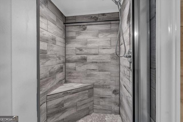 full bath with a tile shower