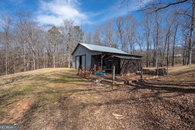 exterior space featuring a garage, a pole building, and an outdoor structure