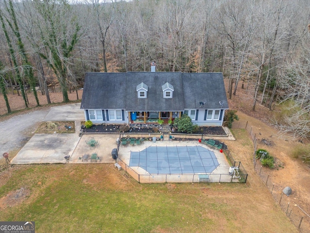 view of pool featuring a covered pool, a lawn, fence, and a patio