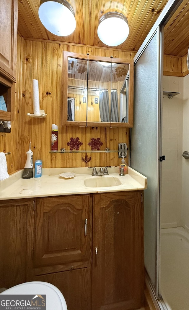 full bath with wood walls, a stall shower, wooden ceiling, and vanity