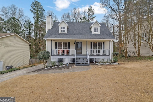 cape cod-style house featuring a shingled roof, a chimney, a front lawn, and a porch