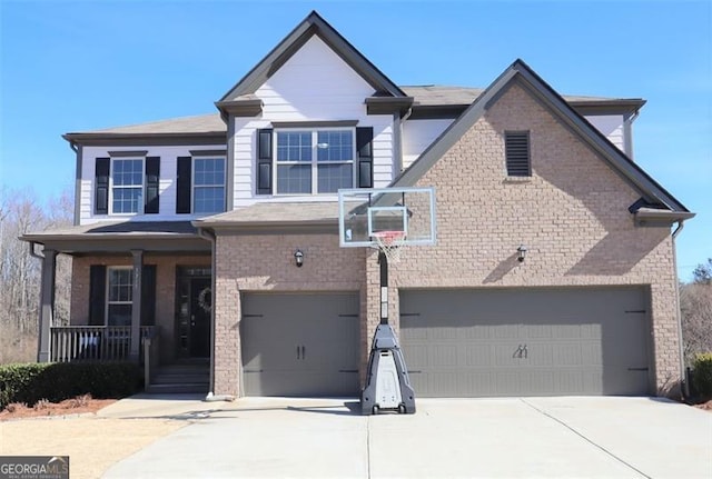 view of front of home with a porch, an attached garage, and brick siding