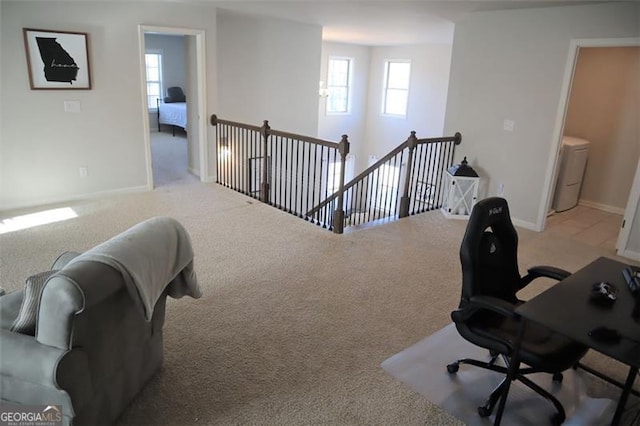 carpeted office space featuring baseboards