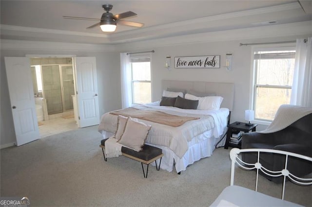 bedroom featuring ensuite bathroom, ceiling fan, carpet floors, ornamental molding, and a raised ceiling