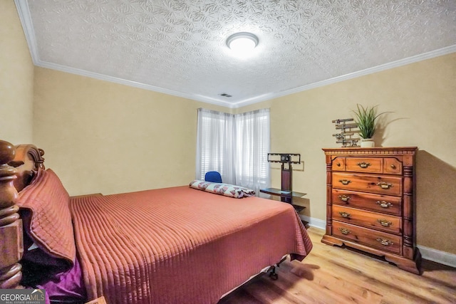 bedroom featuring ornamental molding, light wood-type flooring, and baseboards