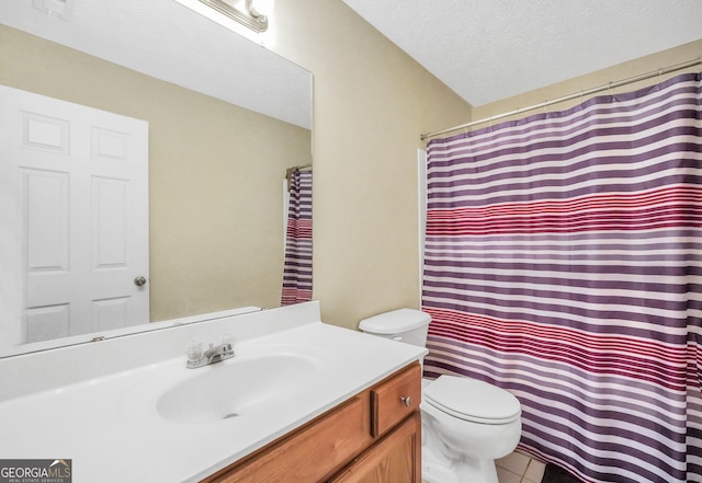 bathroom featuring a shower with shower curtain, toilet, tile patterned flooring, a textured ceiling, and vanity