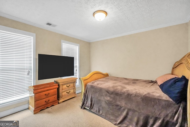 bedroom with light carpet, multiple windows, visible vents, and a textured ceiling