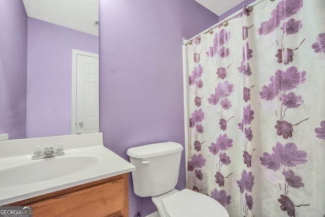 bathroom featuring vanity, toilet, and a shower with curtain