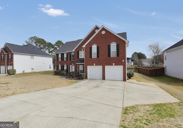 view of front of house featuring a garage, driveway, brick siding, and a front lawn