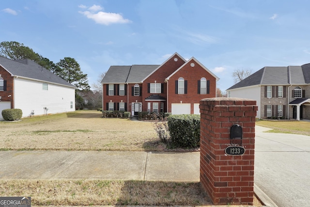 view of front facade featuring brick siding and a front yard