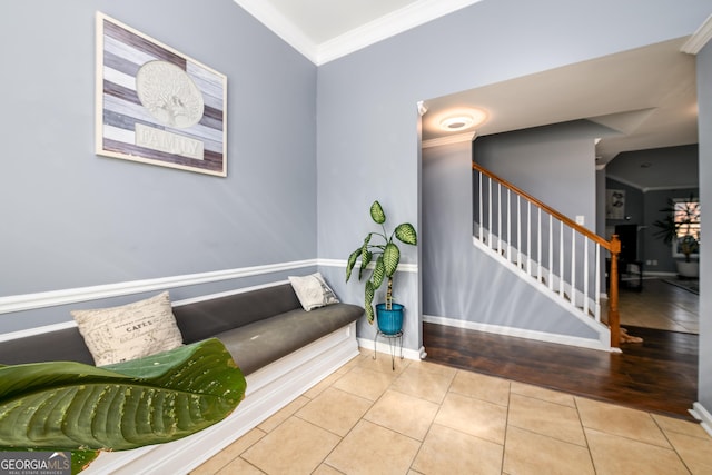 sitting room with baseboards, stairway, tile patterned flooring, and crown molding