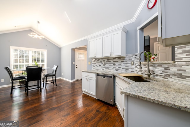 kitchen featuring vaulted ceiling, stainless steel dishwasher, backsplash, and light stone countertops