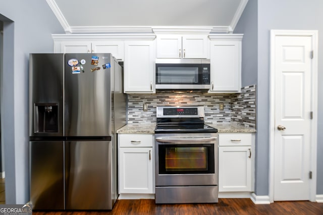 kitchen featuring appliances with stainless steel finishes, white cabinets, crown molding, and decorative backsplash