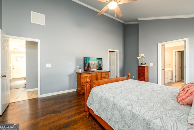 bedroom featuring high vaulted ceiling, ornamental molding, wood finished floors, and visible vents