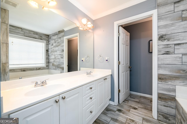 full bath featuring double vanity, visible vents, a sink, and a bath