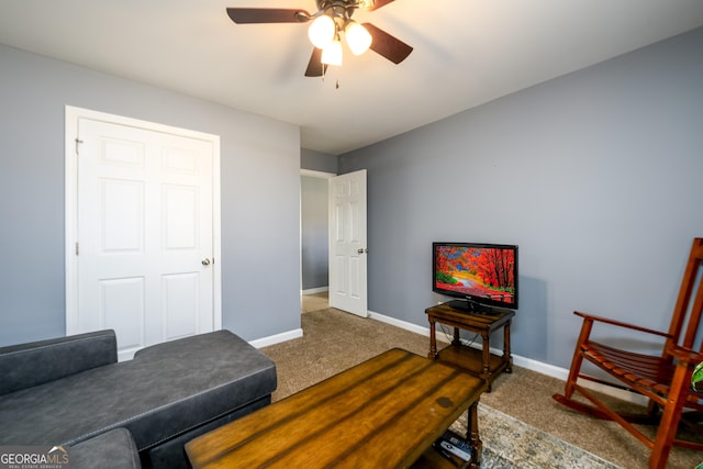 living area featuring a ceiling fan, carpet flooring, and baseboards