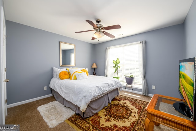 bedroom featuring carpet floors, baseboards, and a ceiling fan