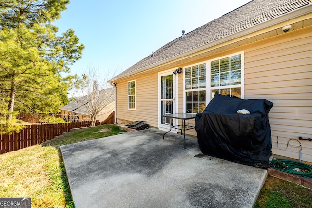 view of patio / terrace featuring a grill and fence