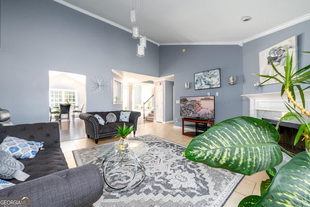 tiled living area with high vaulted ceiling, a high end fireplace, crown molding, and stairs