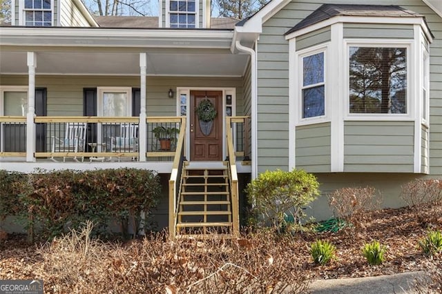 view of exterior entry featuring a porch